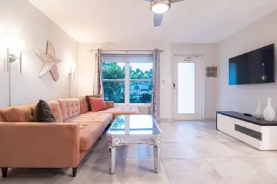 a living room with a couch and a table at Wilton Manors 2BR Bungalow, Private Pool, Sleeps 6 in Fort Lauderdale