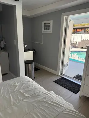 a bedroom with a bed and a swimming pool at Room in Miami