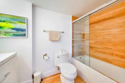a bathroom with a toilet and a glass shower at Modern Waterfront Apartment with Brickell City Views in Miami