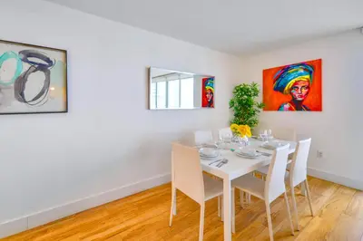 a white dining room with a white table and chairs at Modern Waterfront Apartment with Brickell City Views in Miami