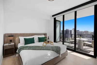 a bedroom with a bed and a large window at Chic 2BR Apartment Gym & Balcony Views in Miami Beach