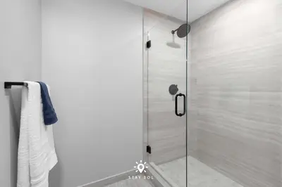 a shower with a glass door in a bathroom at Beautiful Apt -Private Balcony & Pool in Miami Beach