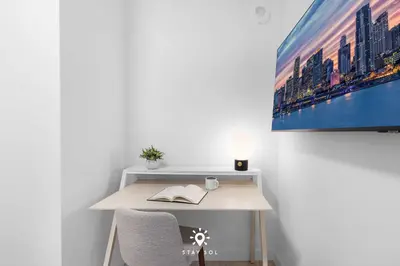 a desk with a book on it in a room at Beautiful Apt -Private Balcony & Pool in Miami Beach