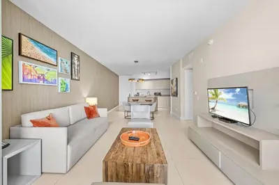 a living room with a couch and a tv at Lyfe Resort & Residences in Hollywood