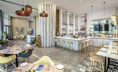 a restaurant with tables and chairs and a bar at Lyfe Resort & Residences in Hollywood
