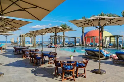 a pool with tables and chairs and umbrellas at Lyfe Resort & Residences in Hollywood