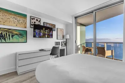 a bedroom with a large white bed and a desk and a window at Ocean Luxe Pad for 6 Guests with Poolside Access in Hollywood