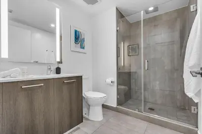 a bathroom with a toilet and a shower at Downtown Luxe Studio Miami Skyline Retreat in Miami