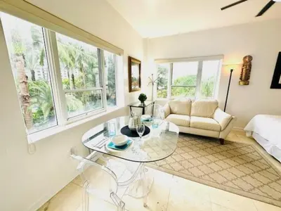 a living room with a glass table and a couch at South Beach Paradise Jr Suite next to Convention Center in Miami Beach