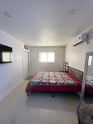 a bedroom with a bed and a television in it at Miramar's Studio in Miramar