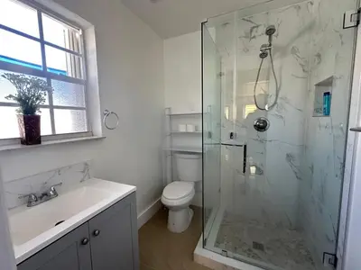 a bathroom with a shower and a toilet and a sink at Miramar's Studio in Miramar