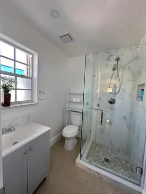 a bathroom with a shower and a toilet and a sink at Miramar's Studio in Miramar