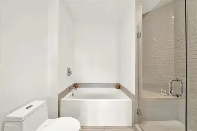 a white bathroom with a toilet and a shower at Oceanfront Escape with Resort-Style Amenities in Hollywood