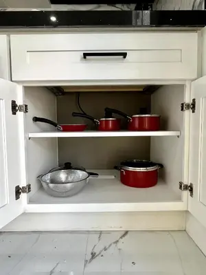 a kitchen with red pots and pans in a cabinet at Lovely and Private Studio