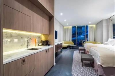 a hotel room with two beds and a sink at SLS Lux Brickell Exclusive by Palermo Home Miami in Miami