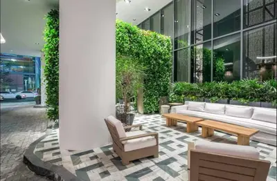 a lobby with couches and chairs in a building at SLS Lux Brickell Exclusive by Palermo Home Miami in Miami