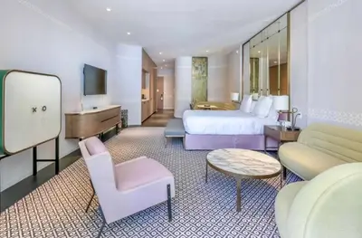 a large hotel room with a bed and a piano at SLS Lux Brickell Exclusive by Palermo Home Miami in Miami