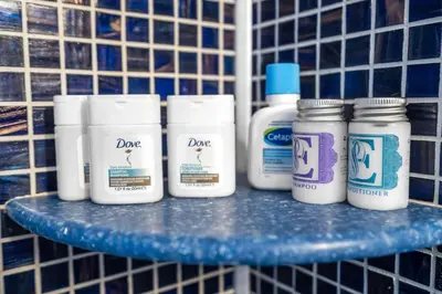 a shelf with four bottles of paint on it at Prized by Florida |Private Pool and HotTub Oasis| in Fort Lauderdale