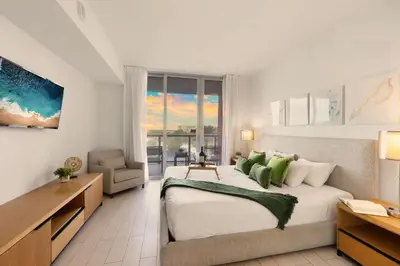 a bedroom with a large bed and a window at Amazing 2 BR Apartment Pool & Near Beach in Hallandale Beach