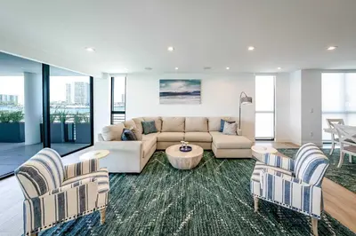 a living room with a couch and two chairs at Bayview Villa by Rove Travel - Waterfront with Patio in Miami Beach