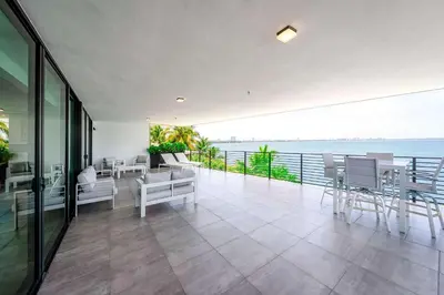 a room with a balcony with a view of the ocean at Bayview Villa by Rove Travel - Waterfront with Patio in Miami Beach