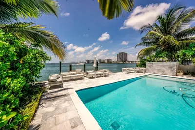 a swimming pool with a view of the water at Bayview Villa by Rove Travel - Waterfront with Patio in Miami Beach
