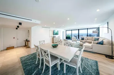 a dining room and living room with a table and chairs at Bayview Villa by Rove Travel - Waterfront with Patio in Miami Beach