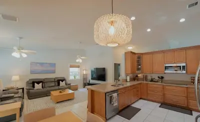 a large kitchen and living room with a couch at Poolside Miami Paradise with BBQ & Outdoor Lounge in Miami
