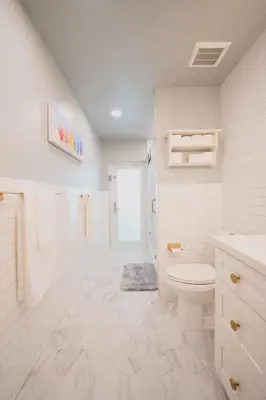 a white bathroom with a toilet and a shower at Poolside Miami Paradise with BBQ & Outdoor Lounge in Miami