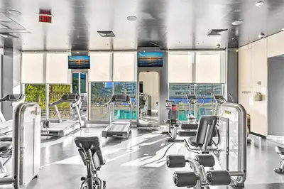 a gym with cardio machines and treadmills at Luxury Ocean View Penthouse 2501 Hallandale Beach in Hallandale Beach