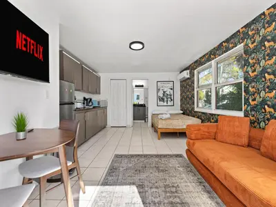 a living room with a couch and a kitchen at Studio Sol Little Havana Retreat in Miami