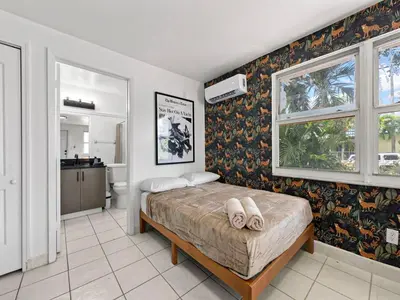 a bedroom with a bed with two towels on it at Studio Sol Little Havana Retreat in Miami