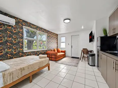 a living room with a bed and a kitchen at Studio Sol Little Havana Retreat in Miami