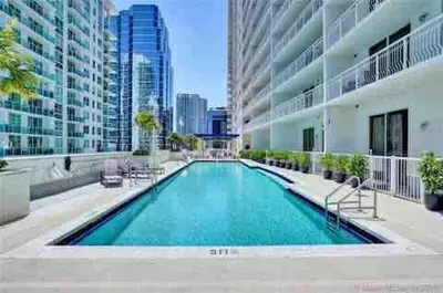 a swimming pool in the middle of a building at Stylish 1BR Modern Apt in Brickell - Free Parking in Miami