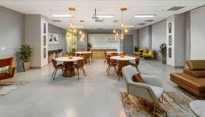 a lobby with tables and chairs in a room at Stylish 1BR Modern Apt in Brickell - Free Parking in Miami