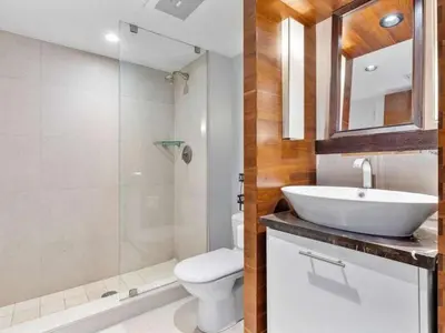 a bathroom with a sink and a toilet and a shower at Villa Seafoam in Miami Beach