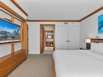 a bedroom with a large white bed and a window at Villa Seafoam in Miami Beach