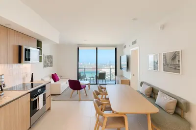 a kitchen and living room with a table and chairs at Luxury 3BR Apt with Epic Biscayne Bay Views in Miami