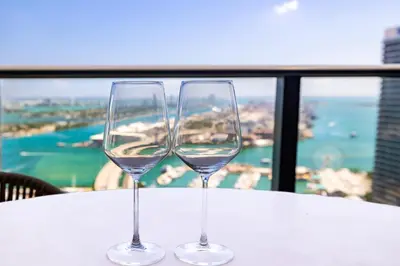 two wine glasses sitting on top of a table at Luxury 3BR Apt with Epic Biscayne Bay Views in Miami