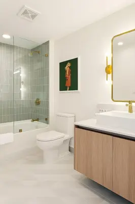 a bathroom with a toilet and a sink and a mirror at Luxury 3BR Apt with Epic Biscayne Bay Views in Miami