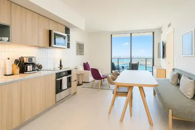 a kitchen and living room with a table and chairs at Luxury 3BR Apt with Epic Biscayne Bay Views in Miami