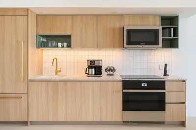 a kitchen with a stove and a microwave at Luxury 3BR Apt with Epic Biscayne Bay Views in Miami