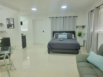a bedroom with a bed with a stuffed animal on it at Kevin#B Chic Studio with Patio near Fort Lauderdale Beach in Fort Lauderdale