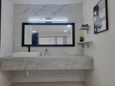 a bathroom with a sink and a large mirror at Kevin#B Chic Studio with Patio near Fort Lauderdale Beach in Fort Lauderdale