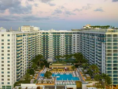 an aerial view of a large building with a pool at Villa DecoBlu in Miami Beach