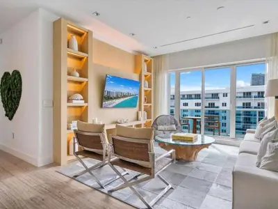 a living room with a couch and a table at Villa DecoBlu in Miami Beach