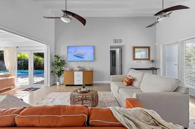 a living room with a couch and a table at 3-Bedroom Villa with Heated Pool near Wilton Drive & Fort Lauderdale Beach in Fort Lauderdale