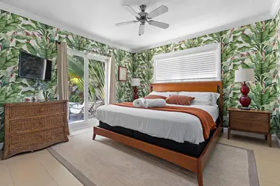 a bedroom with a bed and a television in it at 3-Bedroom Villa with Heated Pool near Wilton Drive & Fort Lauderdale Beach in Fort Lauderdale