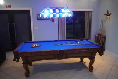 a pool table sitting in a living room with at Riverfront- Home in Hollywood