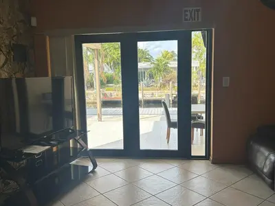 a living room with a sliding glass door leading to a patio at Riverfront- Home in Hollywood